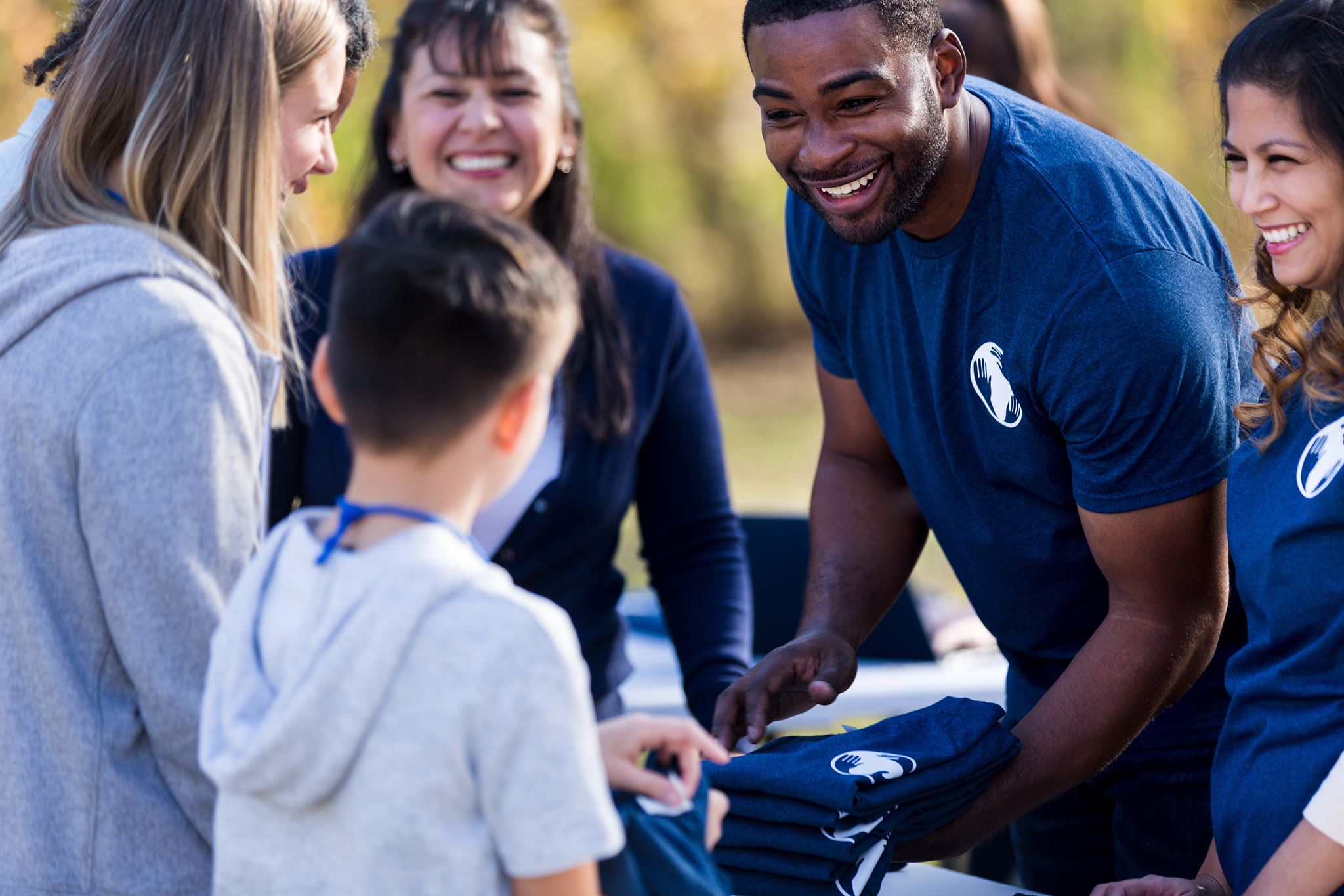 Smiling volunteers helping at community event
